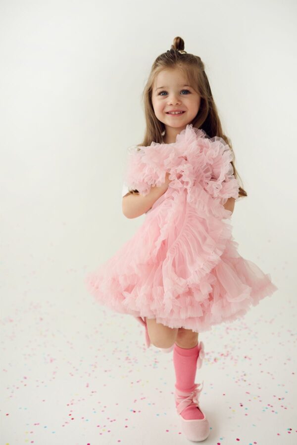 Pink pettiskirt tutu skirt for a girl with pink ruffles and pink knee-high socks for a girl with a pink bow
