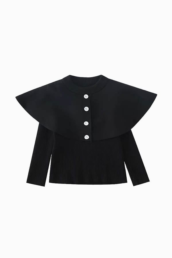 Black cotton poncho-style jumper for a girl with white buttons