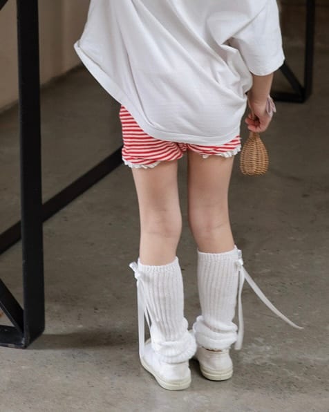 White leg warmers with a bow, paired with matching red and white striped shorts, for a girl