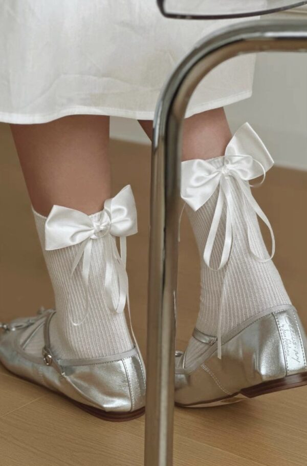 Socks with silk bow, white, with ribbon, for a girl, made of soft material.
