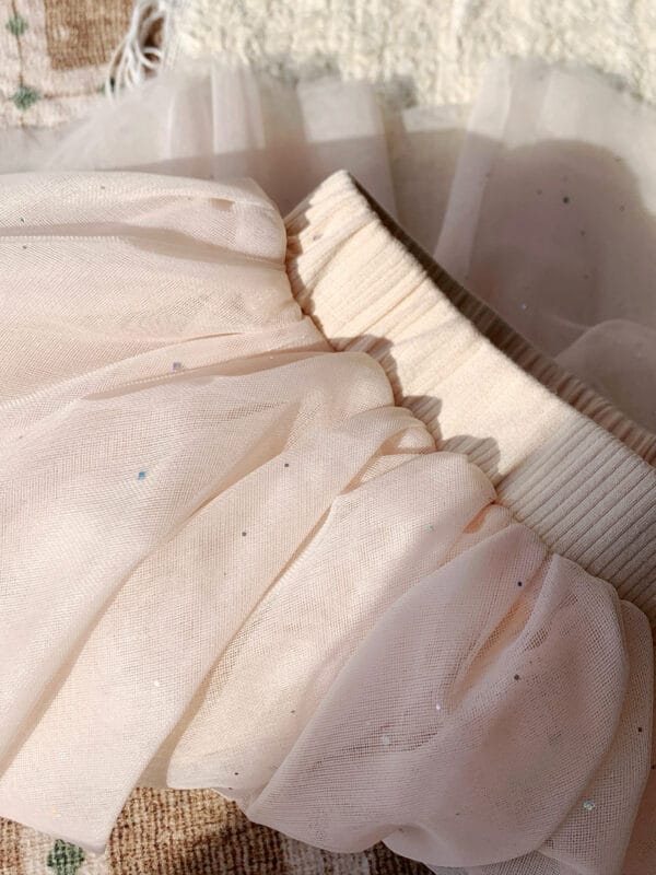 Pink tulle skirt for a girl with delicate ruffles and glitter accents