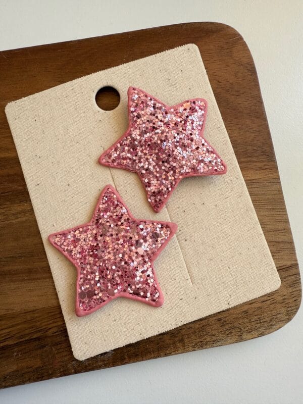 Pink star-shaped hair clips with glitter, set of 2 pieces for a girl.