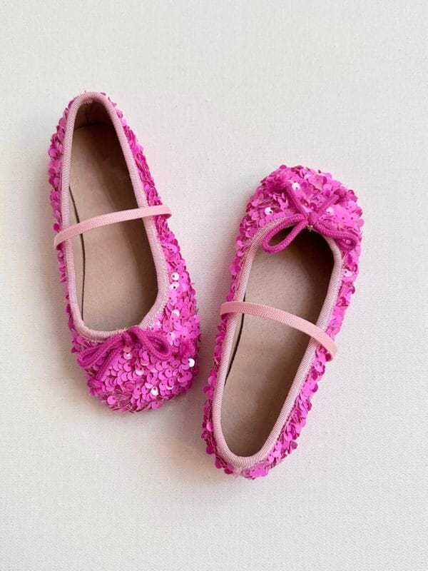 Pink sequin-covered ballerinas for girls with elastic band and bow.