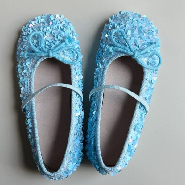 Light blue girl's ballet flats adorned with shimmering sequins and a decorative bow.