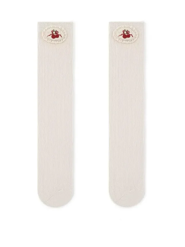 Calcetines de niña de color crema con bordado de cerezas en la banda elástica.