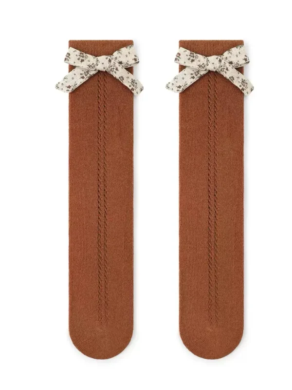 Socks for girls in brown color, decorated with a floral bow and openwork pattern.