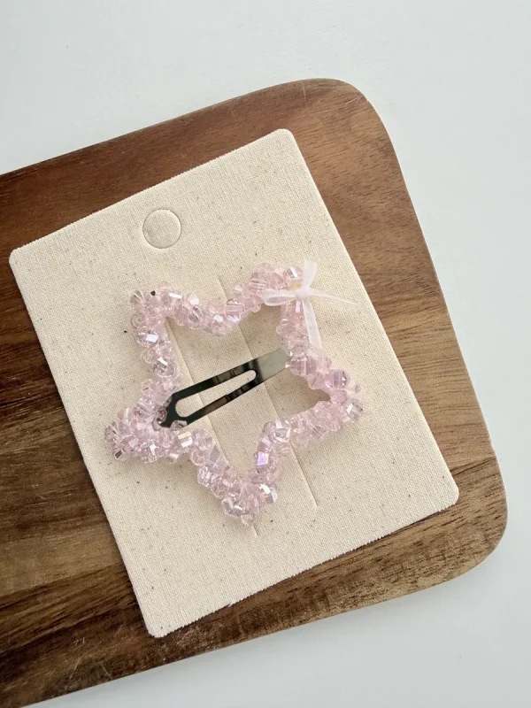 Pink heart-shaped hair clip with shiny beads for a girl
