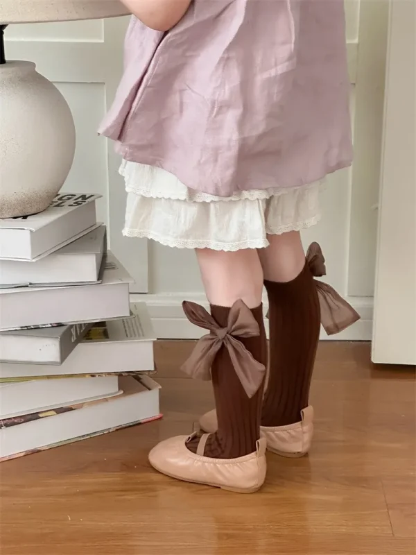 Brown socks with bows for a girl, to match light-coloured ballet flats.
