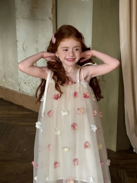Light beige dress for a girl with floral appliqués, delicate and floaty. Available sizes: 98/104, 104/110, 110/116, 122/128, 134