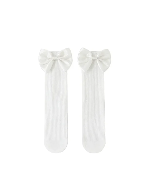 White socks for a girl with a decorative bow at the top.