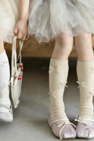 Cream-colored knee-high socks with multiple bows
