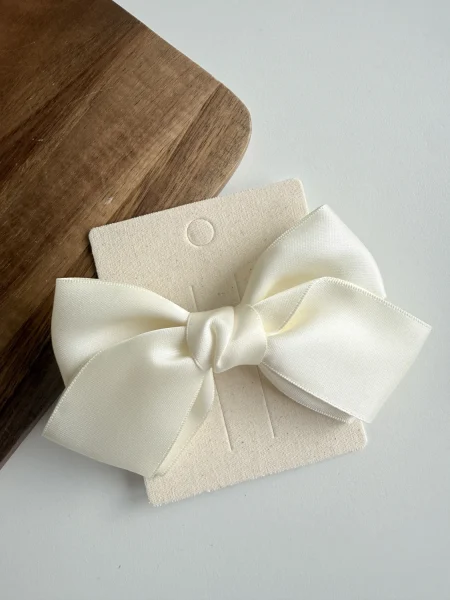 Wide cream satin bow for a girl