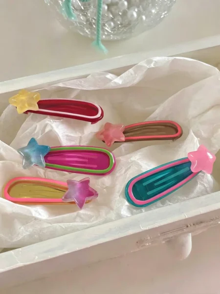 Set of colourful star-shaped hair clips for girls in shades of pink, blue and yellow