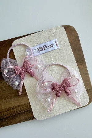 Pink hair clips for girls with pearl accents and lace bows.