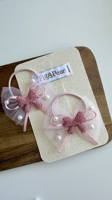Pink hair clips for girls with pearl accents and lace bows.