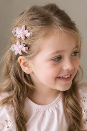 Pink starfish-shaped hair clips for girls, decorated with bows.