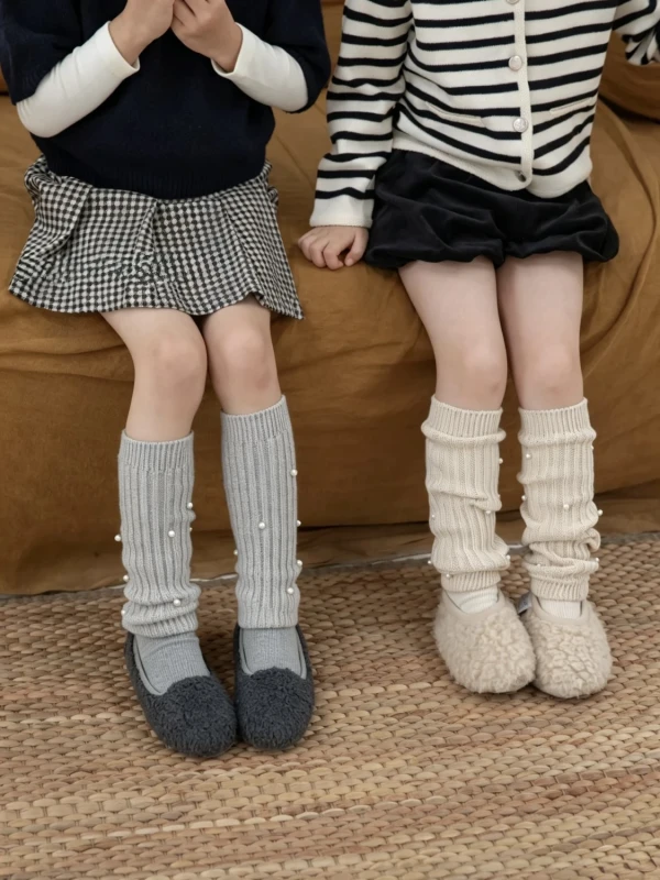 Grey and cream girls’ socks with pearls, paired with comfortable shoes.